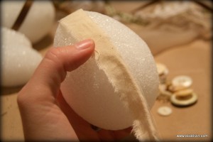 Wrapping the egg with strips of muslin.